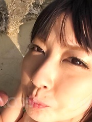 Megumi Haruka Asian busty strokes and licks dong head outdoor