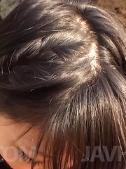 Megumi Haruka Asian busty strokes and licks dong head outdoor