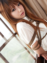 Dimdim Asian in tight office skirt and blouse is tied in ropes