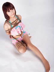 Ayako Asian leering babe has big smile on face as is tied in rope