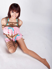 Ayako Asian leering babe has big smile on face as is tied in rope