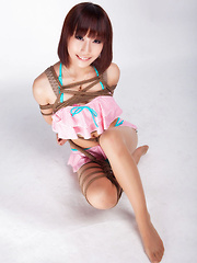Ayako Asian leering babe has big smile on face as is tied in rope