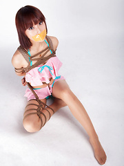 Ayako Asian leering babe has big smile on face as is tied in rope