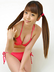 Mizuho Shiraishi with cans in pink bath suit plays with her hair